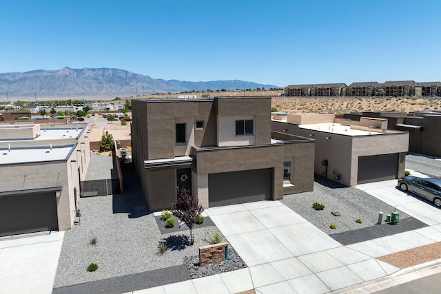 4381 Lauren Loop NE, Rio Rancho, NM 87124 - view of front of property with a mountain view, stucco siding, driveway, and a garage