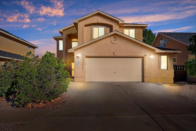 10431 Crosscut Dr NW, Albuquerque, NM 87114 - view of front of house featuring concrete driveway, stucco siding, and an attached garage
