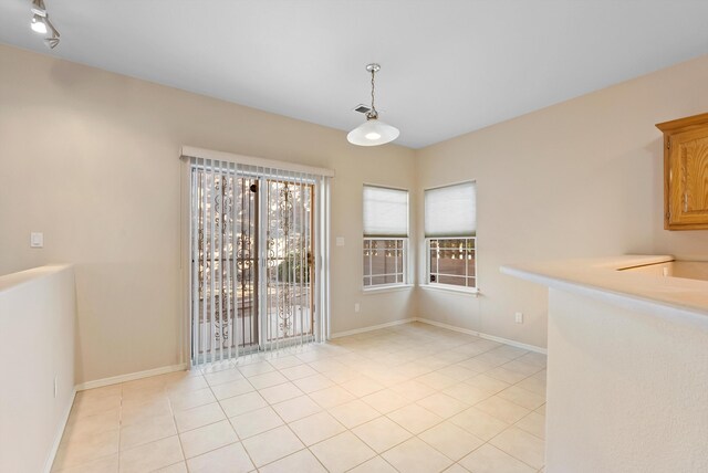 10431 Crosscut Dr NW, Albuquerque, NM 87114 - unfurnished dining area featuring light tile patterned floors and baseboards
