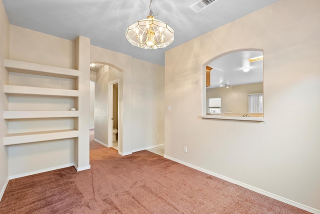 10431 Crosscut Dr NW, Albuquerque, NM 87114 - carpeted spare room featuring arched walkways and a chandelier