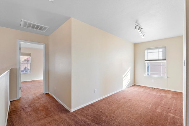 10431 Crosscut Dr NW, Albuquerque, NM 87114 - carpeted empty room featuring baseboards and rail lighting