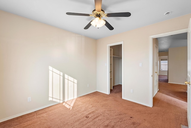 10431 Crosscut Dr NW, Albuquerque, NM 87114 - unfurnished bedroom featuring carpet floors, a walk in closet, a closet, and ceiling fan