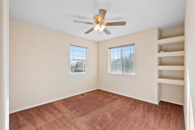 10431 Crosscut Dr NW, Albuquerque, NM 87114 - empty room featuring carpet, ceiling fan, and built in shelves