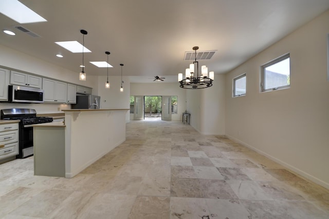 1228 Lafayette Dr NE, Albuquerque, NM 87106 - kitchen with appliances with stainless steel finishes, open floor plan, a skylight, a chandelier, and hanging light fixtures