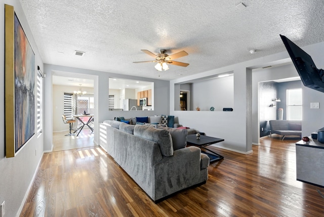 10636 Mcmichael Ln SW, Albuquerque, NM 87121 - living room with a chandelier, a ceiling fan, wood finished floors, and a textured ceiling