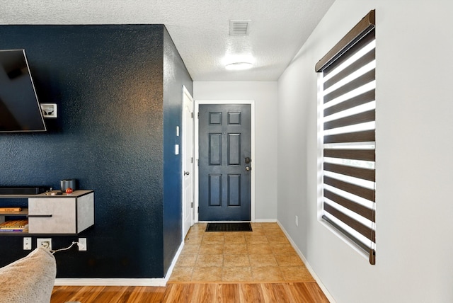 10636 Mcmichael Ln SW, Albuquerque, NM 87121 - entryway with a textured ceiling and light wood-style flooring