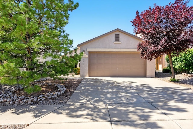 10636 Mcmichael Ln SW, Albuquerque, NM 87121 - view of front of property featuring stucco siding, driveway, and a garage