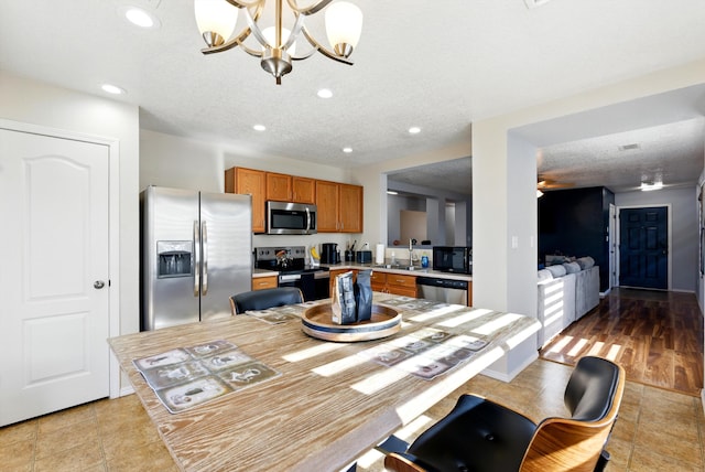 10636 Mcmichael Ln SW, Albuquerque, NM 87121 - dining space with recessed lighting, a chandelier, and a textured ceiling