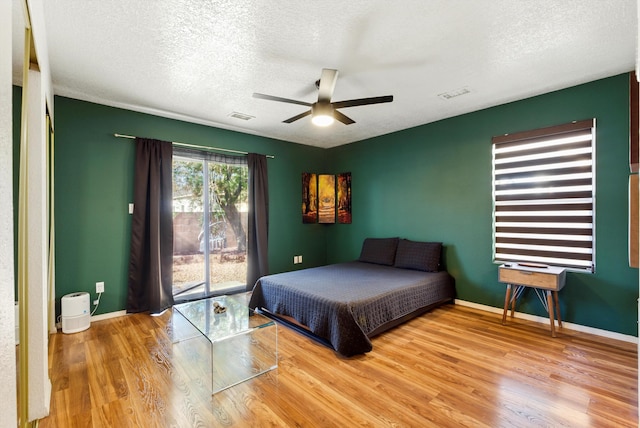 10636 Mcmichael Ln SW, Albuquerque, NM 87121 - bedroom featuring wood finished floors, a textured ceiling, access to outside, and ceiling fan