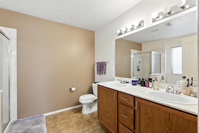 10636 Mcmichael Ln SW, Albuquerque, NM 87121 - bathroom featuring a stall shower, double vanity, and a textured ceiling