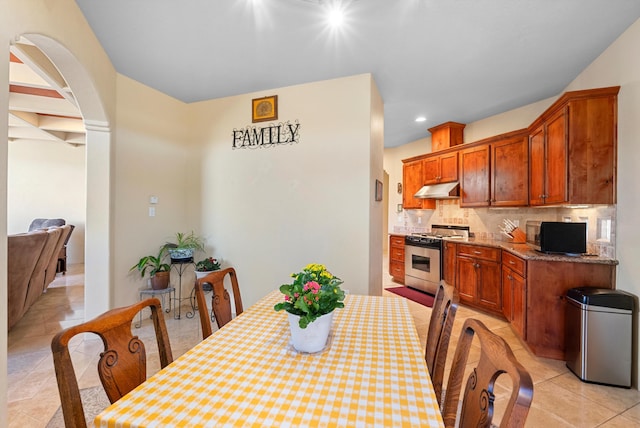3 Seasons Cir, Placitas, NM 87043 - dining area featuring light tile patterned floors, arched walkways, and recessed lighting