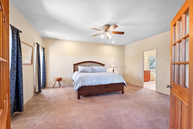 3 Seasons Cir, Placitas, NM 87043 - bedroom featuring carpet floors, ensuite bathroom, ceiling fan, and a textured ceiling