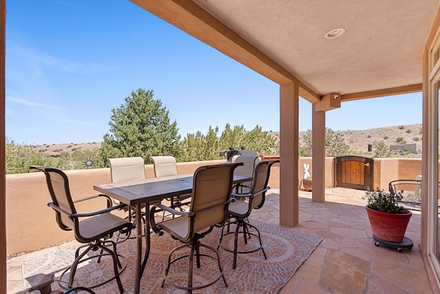 3 Seasons Cir, Placitas, NM 87043 - view of patio / terrace with a mountain view and outdoor dining area