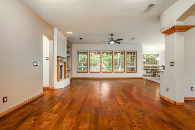 924 Seattle Slew Ave SE, Albuquerque, NM 87112 - unfurnished living room with a ceiling fan, a fireplace, and hardwood / wood-style floors