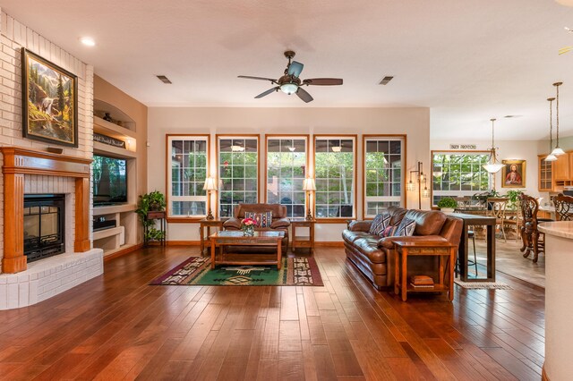 924 Seattle Slew Ave SE, Albuquerque, NM 87112 - living area featuring ceiling fan, a brick fireplace, and hardwood / wood-style flooring