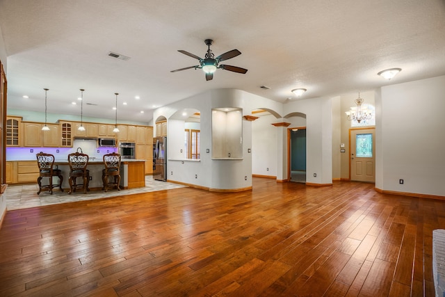 924 Seattle Slew Ave SE, Albuquerque, NM 87112 - living room featuring arched walkways, ceiling fan, a chandelier, light wood-type flooring, and recessed lighting