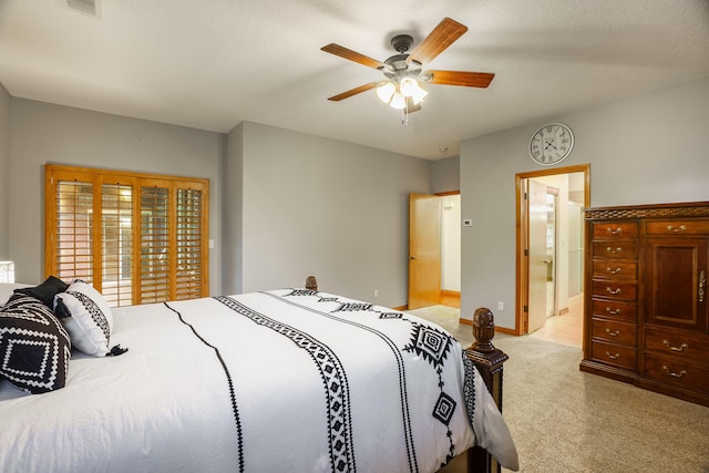 924 Seattle Slew Ave SE, Albuquerque, NM 87112 - bedroom featuring light carpet, a ceiling fan, and ensuite bath
