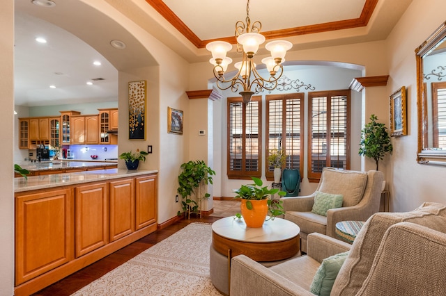 924 Seattle Slew Ave SE, Albuquerque, NM 87112 - living area with a chandelier, arched walkways, dark wood finished floors, recessed lighting, and ornamental molding