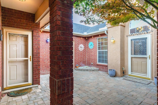 924 Seattle Slew Ave SE, Albuquerque, NM 87112 - doorway to property with brick siding, roof with shingles, and a patio
