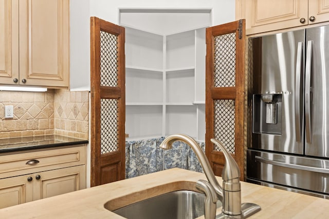 9005 4th St NW, Albuquerque, NM 87114 - kitchen with stainless steel fridge with ice dispenser, backsplash, and cream cabinets