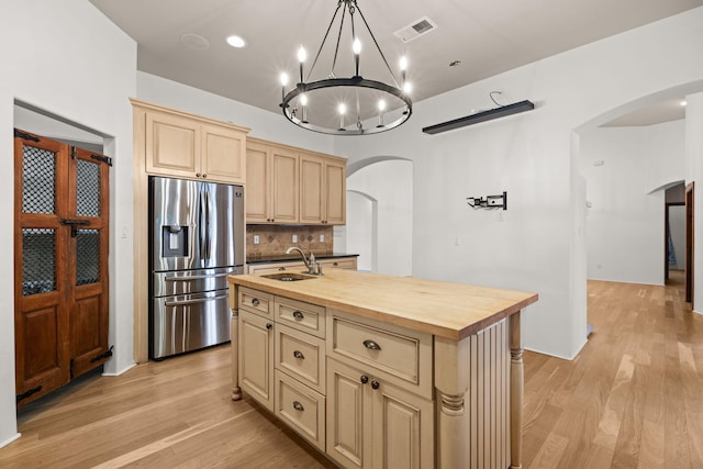 9005 4th St NW, Albuquerque, NM 87114 - kitchen with stainless steel fridge, arched walkways, wood counters, light wood-type flooring, and a chandelier