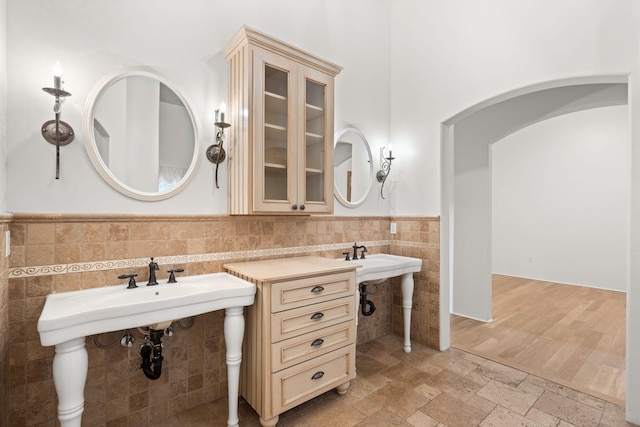 9005 4th St NW, Albuquerque, NM 87114 - bathroom featuring tile walls, a wainscoted wall, and stone tile floors