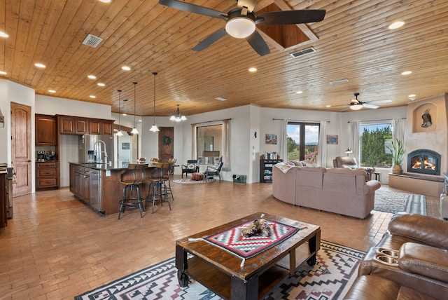 168 Lesperance Rd, Estancia, NM 87016 - living room featuring a ceiling fan, recessed lighting, a large fireplace, and wooden ceiling