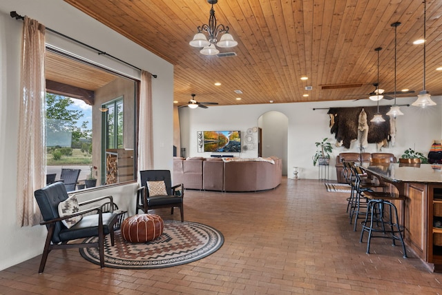 168 Lesperance Rd, Estancia, NM 87016 - living area featuring arched walkways, wooden ceiling, brick floors, ceiling fan, and recessed lighting