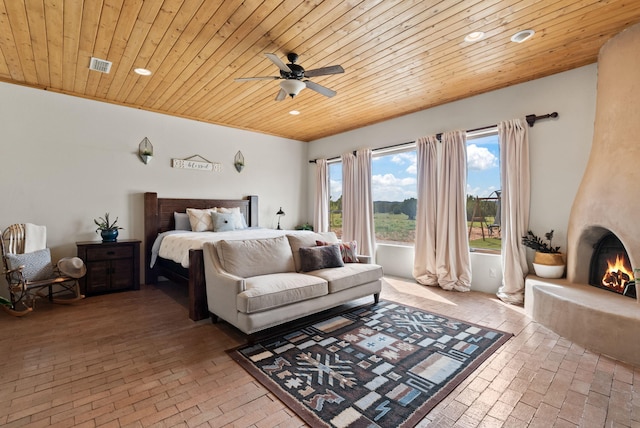 168 Lesperance Rd, Estancia, NM 87016 - bedroom with brick flooring, recessed lighting, wooden ceiling, a fireplace, and a ceiling fan