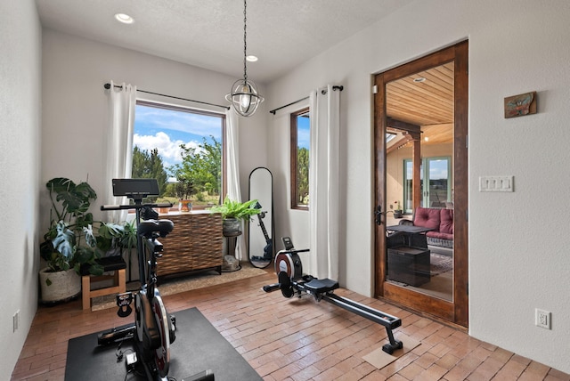 168 Lesperance Rd, Estancia, NM 87016 - exercise room featuring brick floors and recessed lighting