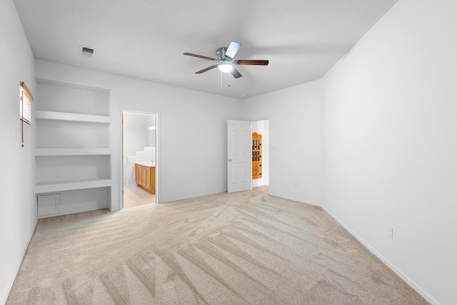 3912 Tundra Swan Ct NW, Albuquerque, NM 87120 - unfurnished bedroom with light carpet, a spacious closet, ensuite bathroom, and ceiling fan