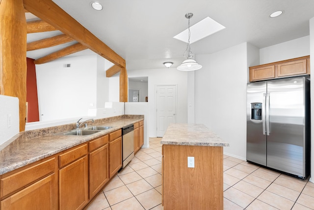 3912 Tundra Swan Ct NW, Albuquerque, NM 87120 - kitchen featuring stainless steel appliances, a kitchen island, a skylight, light countertops, and hanging light fixtures