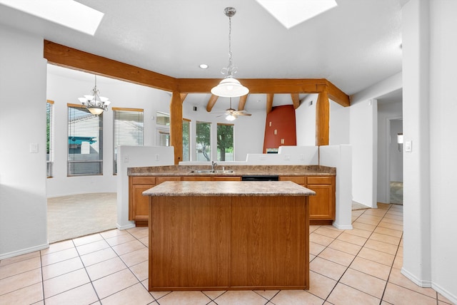 3912 Tundra Swan Ct NW, Albuquerque, NM 87120 - kitchen featuring a skylight, a kitchen island, light tile patterned floors, pendant lighting, and beamed ceiling