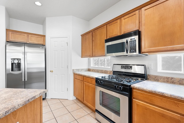 3912 Tundra Swan Ct NW, Albuquerque, NM 87120 - kitchen with stainless steel appliances, light countertops, and light tile patterned floors