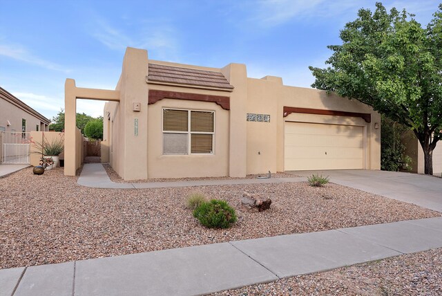 3912 Tundra Swan Ct NW, Albuquerque, NM 87120 - southwest-style home with concrete driveway, stucco siding, and an attached garage