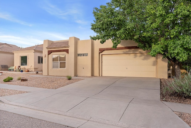 3912 Tundra Swan Ct NW, Albuquerque, NM 87120 - adobe home featuring concrete driveway, stucco siding, a garage, and a tile roof