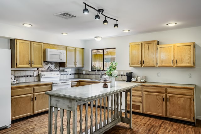 6920 Conestoga Dr NW, Albuquerque, NM 87120 - kitchen with white appliances, dark wood-type flooring, tasteful backsplash, light countertops, and rail lighting