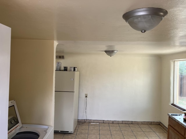 3107 Draxton Ave SW, Albuquerque, NM 87105 - kitchen featuring freestanding refrigerator, washer / clothes dryer, and light tile patterned floors