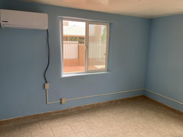3107 Draxton Ave SW, Albuquerque, NM 87105 - unfurnished room featuring a wall mounted air conditioner and baseboards