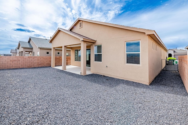 4289 Crowned Eagle Loop NE, Rio Rancho, NM 87144 - rear view of house featuring stucco siding, a patio, and a fenced backyard