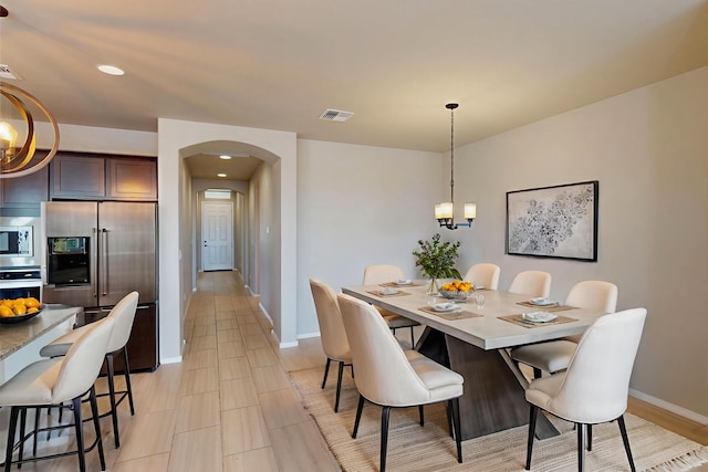 4289 Crowned Eagle Loop NE, Rio Rancho, NM 87144 - dining space with a chandelier, arched walkways, recessed lighting, and light tile patterned floors