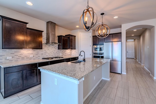 4289 Crowned Eagle Loop NE, Rio Rancho, NM 87144 - kitchen featuring stainless steel appliances, wall chimney range hood, arched walkways, backsplash, and recessed lighting