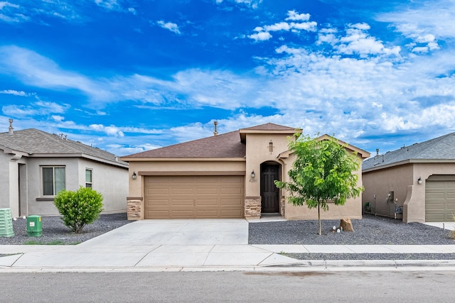 4289 Crowned Eagle Loop NE, Rio Rancho, NM 87144 - view of front of property featuring stucco siding, a garage, driveway, a shingled roof, and stone siding