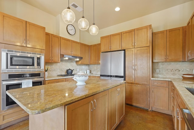 651 Calle De Blas, Corrales, NM 87048 - kitchen featuring appliances with stainless steel finishes, decorative backsplash, a center island, under cabinet range hood, and light stone countertops
