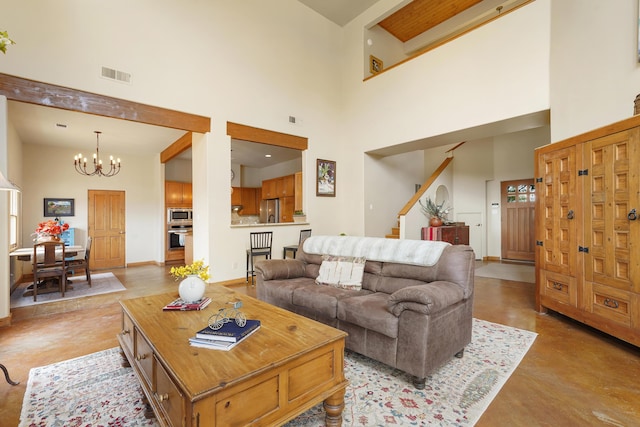 651 Calle De Blas, Corrales, NM 87048 - living area with concrete floors, a towering ceiling, a chandelier, and stairway