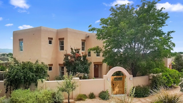 651 Calle De Blas, Corrales, NM 87048 - view of front of property with a fenced front yard, a gate, and stucco siding
