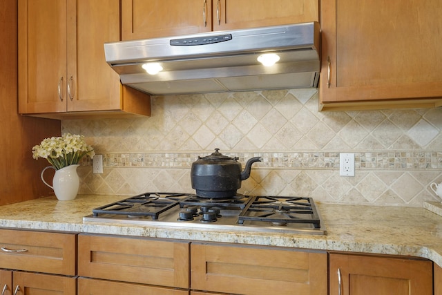 651 Calle De Blas, Corrales, NM 87048 - kitchen featuring extractor fan, decorative backsplash, stainless steel gas stovetop, and light stone counters