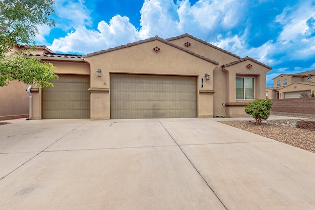 1501 Barbaro Dr SE, Albuquerque, NM 87123 - mediterranean / spanish-style house with an attached garage, stucco siding, and driveway