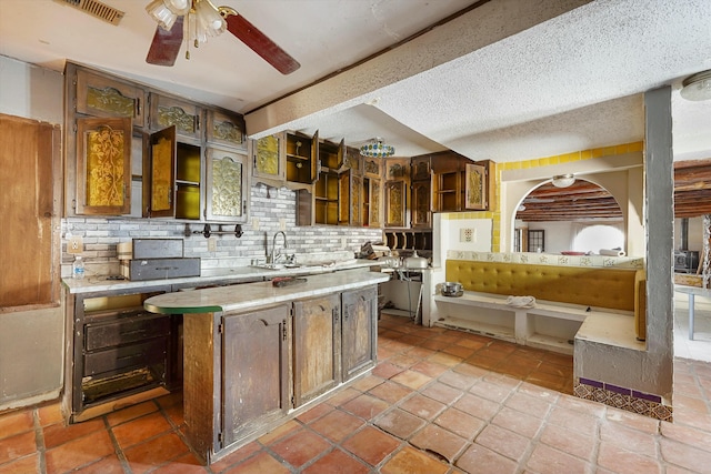 1233 Montrose Pl SW, Albuquerque, NM 87105 - kitchen featuring open shelves, light countertops, backsplash, ceiling fan, and a textured ceiling