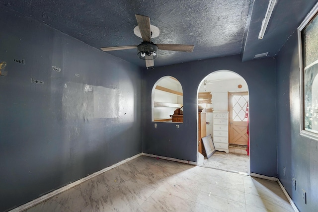1233 Montrose Pl SW, Albuquerque, NM 87105 - unfurnished room with arched walkways and a ceiling fan